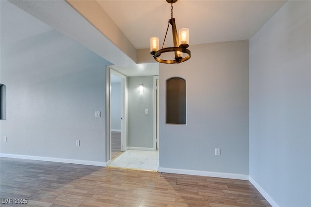 3318 N Decatur Blvd Unit 2110, Las Vegas, NV 89130 - unfurnished room featuring a chandelier, light wood-style flooring, and baseboards