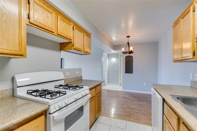 3318 N Decatur Blvd Unit 2110, Las Vegas, NV 89130 - kitchen with white appliances, light countertops, a sink, baseboards, and pendant lighting