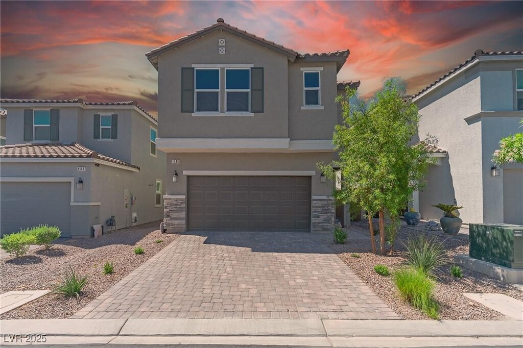 4589 Swimming Minnow Ave, Las Vegas, NV 89141 - view of front of home featuring stucco siding, decorative driveway, a garage, and a tile roof