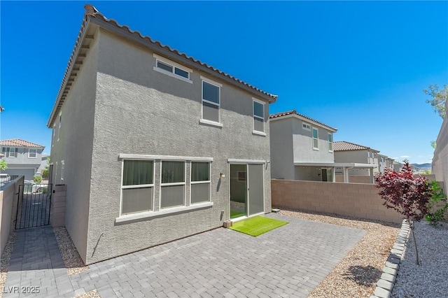 4589 Swimming Minnow Ave, Las Vegas, NV 89141 - rear view of house featuring stucco siding, fence, a patio, and a tiled roof