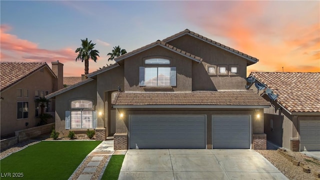 8714 Las Posas Ave, Las Vegas, NV 89147 - view of front of property featuring brick siding, driveway, stucco siding, a lawn, and an attached garage