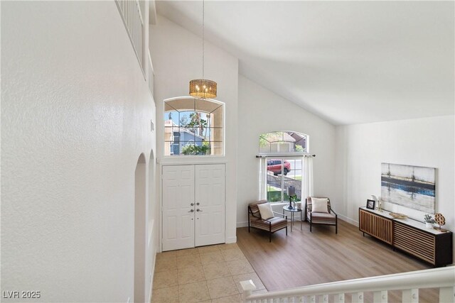 8714 Las Posas Ave, Las Vegas, NV 89147 - foyer entrance featuring high vaulted ceiling, a chandelier, arched walkways, and baseboards