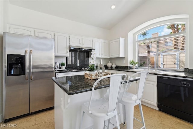 8714 Las Posas Ave, Las Vegas, NV 89147 - kitchen with stainless steel appliances, light tile patterned floors, white cabinetry, recessed lighting, and vaulted ceiling