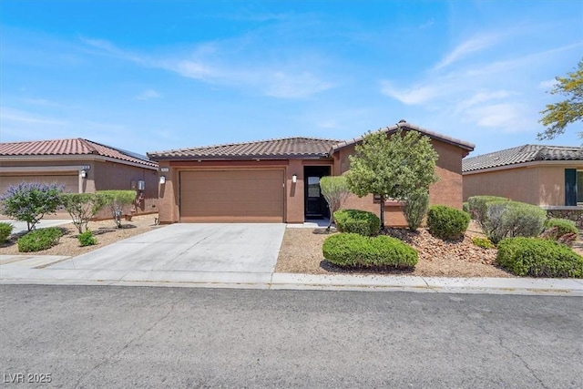 7428 Alamo Ranch Ave, Las Vegas, NV 89179 - view of front of home with a tile roof, an attached garage, stucco siding, and driveway