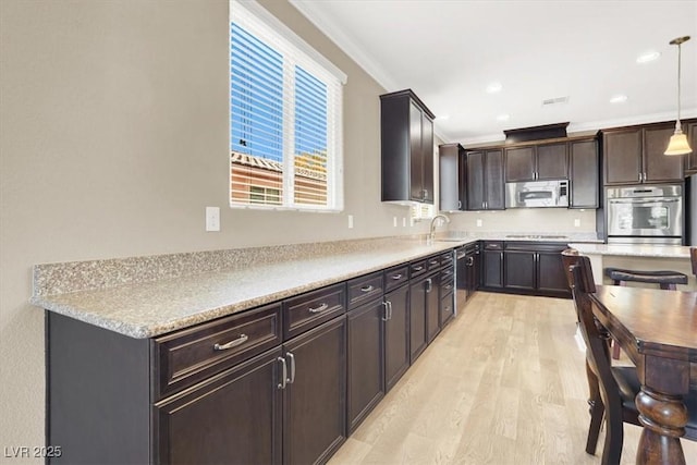 7428 Alamo Ranch Ave, Las Vegas, NV 89179 - kitchen with appliances with stainless steel finishes, crown molding, light wood-style flooring, light countertops, and a sink