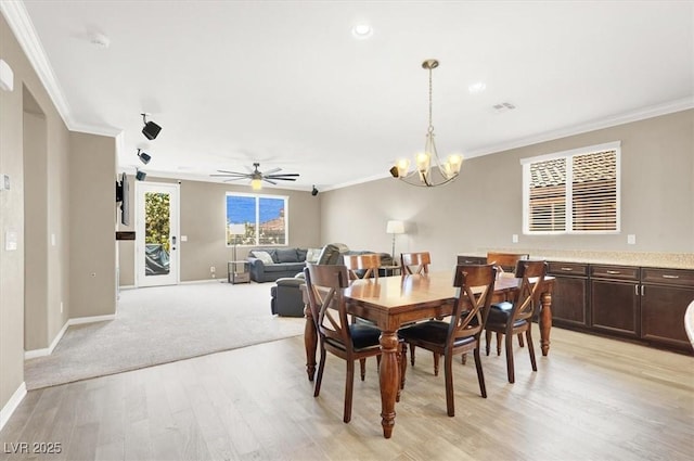 7428 Alamo Ranch Ave, Las Vegas, NV 89179 - dining space with crown molding, light wood-style floors, baseboards, a chandelier, and ceiling fan