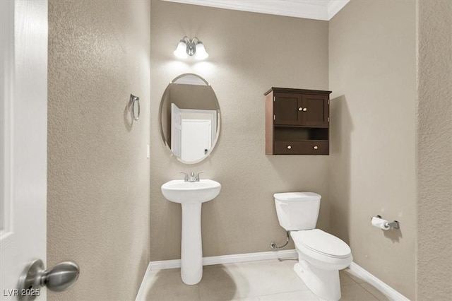 7428 Alamo Ranch Ave, Las Vegas, NV 89179 - half bath featuring tile patterned flooring, toilet, ornamental molding, and baseboards