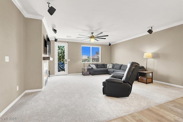 7428 Alamo Ranch Ave, Las Vegas, NV 89179 - living area with baseboards, ceiling fan, ornamental molding, and wood finished floors