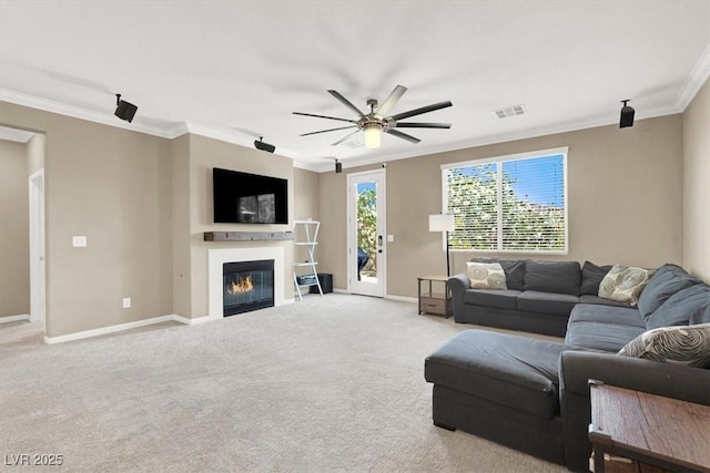7428 Alamo Ranch Ave, Las Vegas, NV 89179 - carpeted living room featuring ornamental molding, ceiling fan, baseboards, and a glass covered fireplace