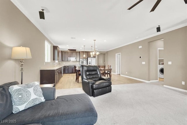 7428 Alamo Ranch Ave, Las Vegas, NV 89179 - living room featuring washer / clothes dryer, baseboards, a ceiling fan, crown molding, and light carpet