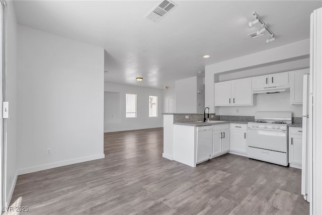 4149 Dignified Ct, North Las Vegas, NV 89032 - kitchen with white appliances, open floor plan, under cabinet range hood, white cabinetry, and a sink