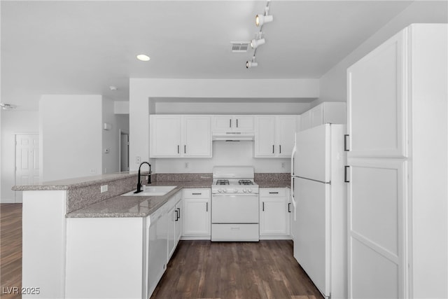 4149 Dignified Ct, North Las Vegas, NV 89032 - kitchen featuring white appliances, a sink, under cabinet range hood, a peninsula, and white cabinetry