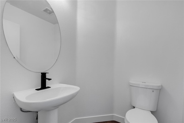 4149 Dignified Ct, North Las Vegas, NV 89032 - half bath featuring a sink, baseboards, and toilet
