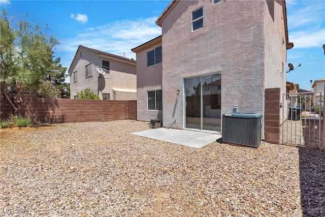 4149 Dignified Ct, North Las Vegas, NV 89032 - rear view of house featuring central AC unit, stucco siding, a fenced backyard, and a patio