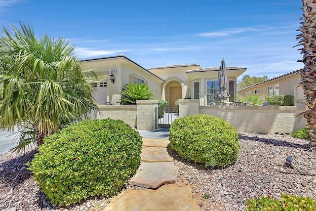 5068 Rivedro St, Las Vegas, NV 89135 - view of front of home featuring a fenced front yard, stucco siding, and a gate