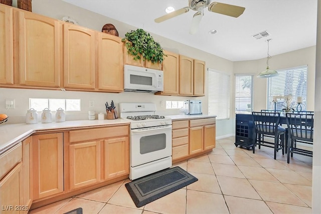 5068 Rivedro St, Las Vegas, NV 89135 - kitchen with white appliances, light brown cabinets, light tile patterned flooring, and light countertops