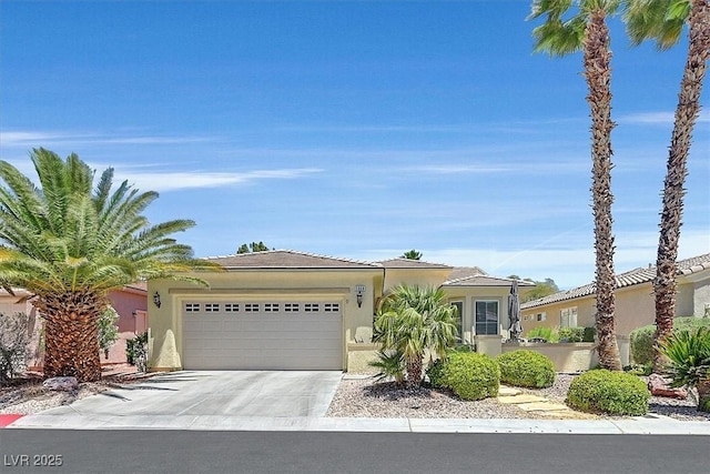 5068 Rivedro St, Las Vegas, NV 89135 - view of front of property with a garage, driveway, and stucco siding