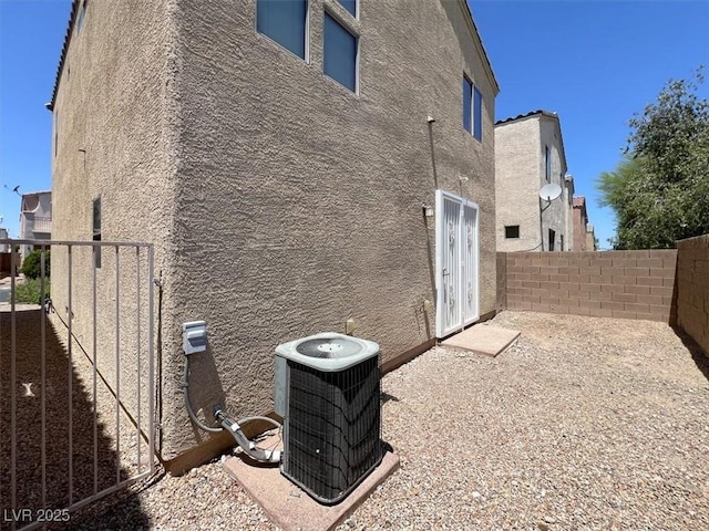 10230 Viterbo St, Las Vegas, NV 89183 - view of side of home with central AC unit, stucco siding, and a fenced backyard