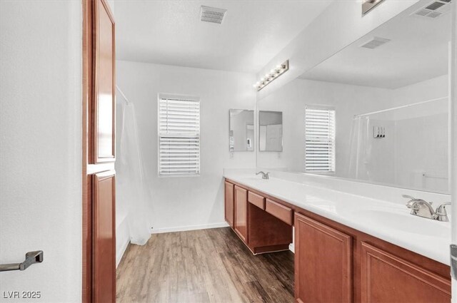 10230 Viterbo St, Las Vegas, NV 89183 - bathroom featuring wood finished floors, double vanity, and baseboards