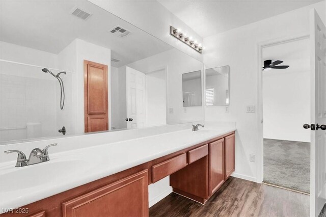 10230 Viterbo St, Las Vegas, NV 89183 - bathroom featuring wood finished floors, double vanity, a shower, and ceiling fan