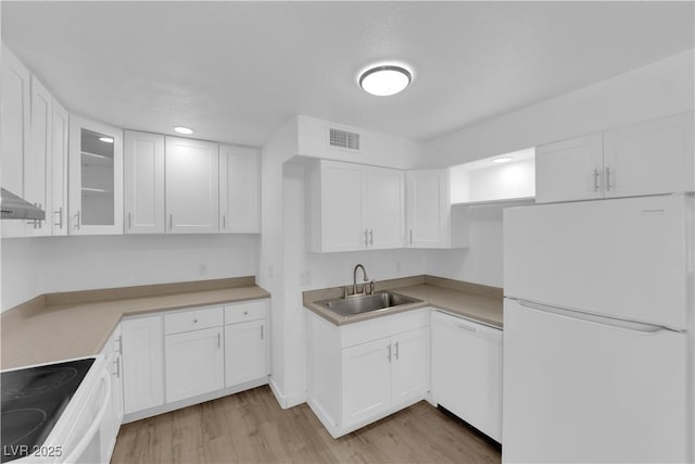 721 Carpenter Dr, Las Vegas, NV 89107 - kitchen featuring white appliances, a sink, light wood-style floors, white cabinetry, and recessed lighting