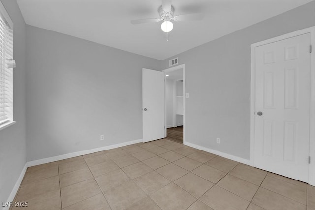 721 Carpenter Dr, Las Vegas, NV 89107 - unfurnished bedroom featuring light tile patterned flooring, baseboards, and ceiling fan