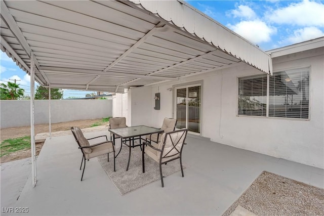 721 Carpenter Dr, Las Vegas, NV 89107 - view of patio featuring outdoor dining space, fence, and electric panel