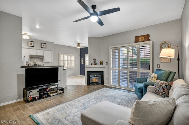 8501 W University Ave Unit 1083, Las Vegas, NV 89147 - living room featuring a ceiling fan, wood finished floors, plenty of natural light, baseboards, and recessed lighting