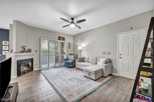 8501 W University Ave Unit 1083, Las Vegas, NV 89147 - living room with ceiling fan, light wood-style flooring, a glass covered fireplace, and baseboards