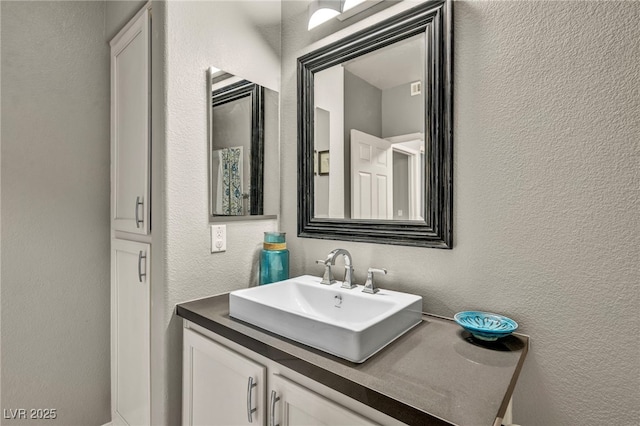 8501 W University Ave Unit 1083, Las Vegas, NV 89147 - bathroom featuring a textured wall and vanity