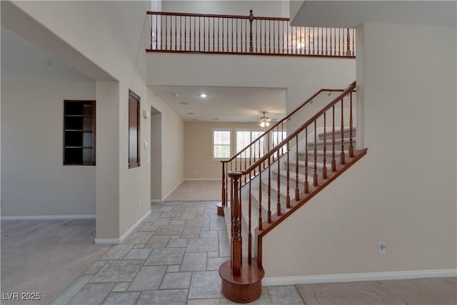 5912 Kit Cove Ct, Las Vegas, NV 89131 - foyer entrance with baseboards, stairs, light stone finish flooring, ceiling fan, and a high ceiling
