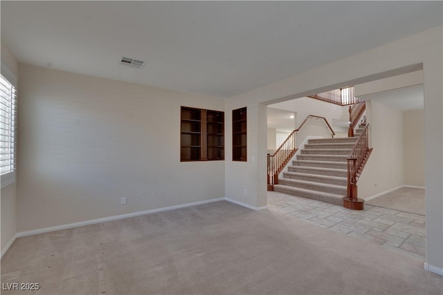 5912 Kit Cove Ct, Las Vegas, NV 89131 - spare room with stairway, baseboards, carpet flooring, and stone finish flooring