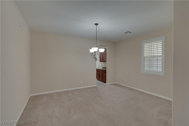 5912 Kit Cove Ct, Las Vegas, NV 89131 - empty room featuring light carpet, a chandelier, and baseboards