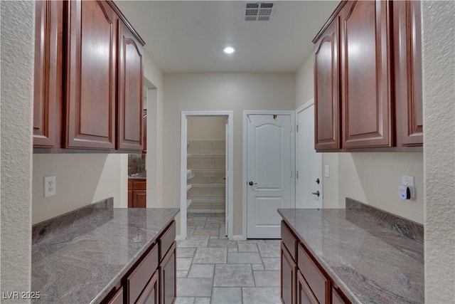5912 Kit Cove Ct, Las Vegas, NV 89131 - kitchen with dark stone countertops, recessed lighting, light stone finish floors, and dark brown cabinets