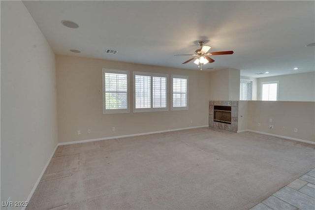 5912 Kit Cove Ct, Las Vegas, NV 89131 - unfurnished living room with a tiled fireplace, ceiling fan, baseboards, light colored carpet, and recessed lighting