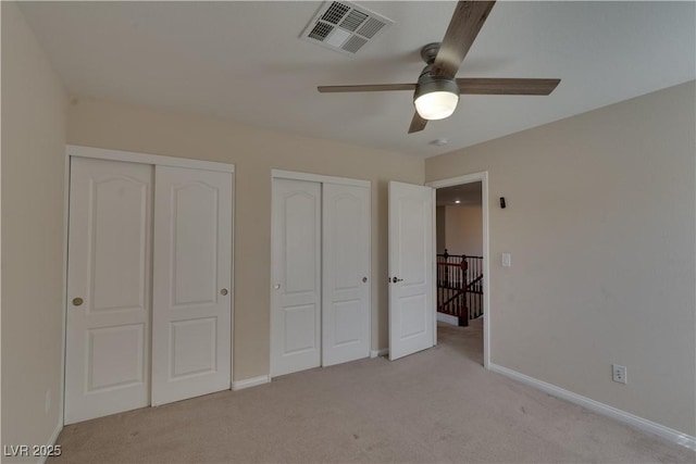 5912 Kit Cove Ct, Las Vegas, NV 89131 - unfurnished bedroom featuring multiple closets, light colored carpet, baseboards, and ceiling fan