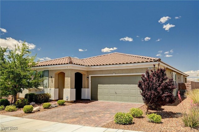2902 Ventana Ridge Ave, Henderson, NV 89044 - mediterranean / spanish house featuring a tiled roof, decorative driveway, a garage, and stucco siding