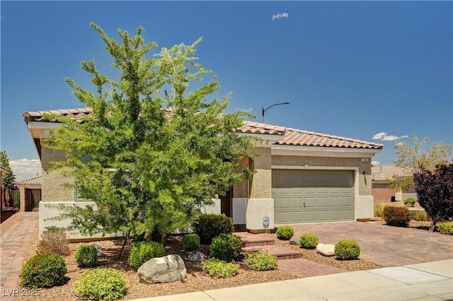 2902 Ventana Ridge Ave, Henderson, NV 89044 - view of front of home featuring a tile roof, decorative driveway, an attached garage, and stucco siding