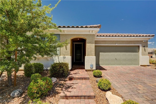 2902 Ventana Ridge Ave, Henderson, NV 89044 - mediterranean / spanish-style home featuring stucco siding, an attached garage, a tile roof, and driveway