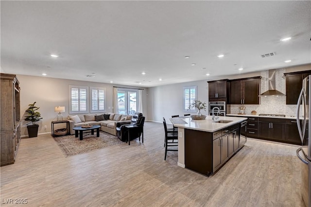 2902 Ventana Ridge Ave, Henderson, NV 89044 - kitchen featuring wall chimney exhaust hood, healthy amount of natural light, open floor plan, light countertops, and recessed lighting