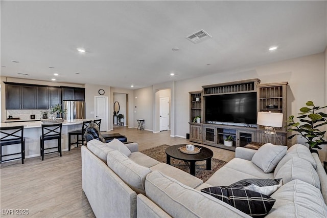 2902 Ventana Ridge Ave, Henderson, NV 89044 - living area featuring recessed lighting, arched walkways, light wood finished floors, and baseboards
