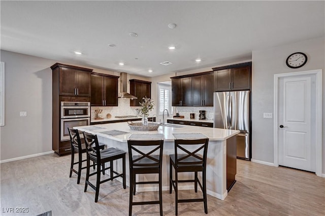 2902 Ventana Ridge Ave, Henderson, NV 89044 - kitchen with stainless steel appliances, a kitchen bar, dark brown cabinets, backsplash, and recessed lighting