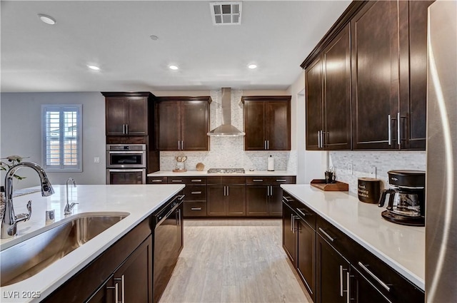 2902 Ventana Ridge Ave, Henderson, NV 89044 - kitchen with a sink, stainless steel appliances, wall chimney range hood, light wood-type flooring, and backsplash