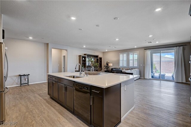 2902 Ventana Ridge Ave, Henderson, NV 89044 - kitchen with a sink, dishwasher, open floor plan, dark brown cabinets, and light wood-style flooring