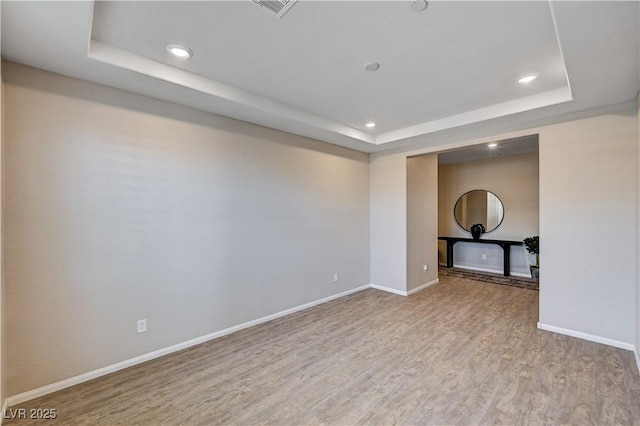 2902 Ventana Ridge Ave, Henderson, NV 89044 - unfurnished room featuring a tray ceiling, wood finished floors, baseboards, and recessed lighting