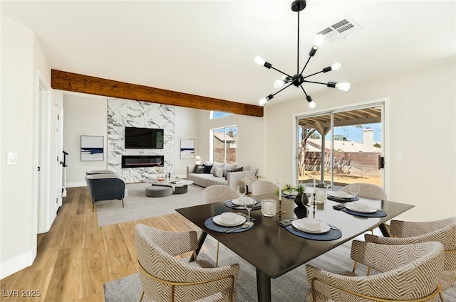 1724 Navajo Lake Way, Las Vegas, NV 89128 - dining area featuring a chandelier, light wood-style flooring, and a premium fireplace