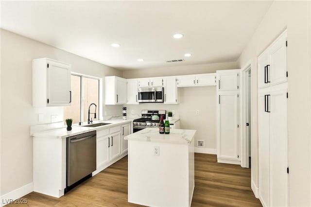 1724 Navajo Lake Way, Las Vegas, NV 89128 - kitchen featuring appliances with stainless steel finishes, a sink, white cabinetry, baseboards, and recessed lighting