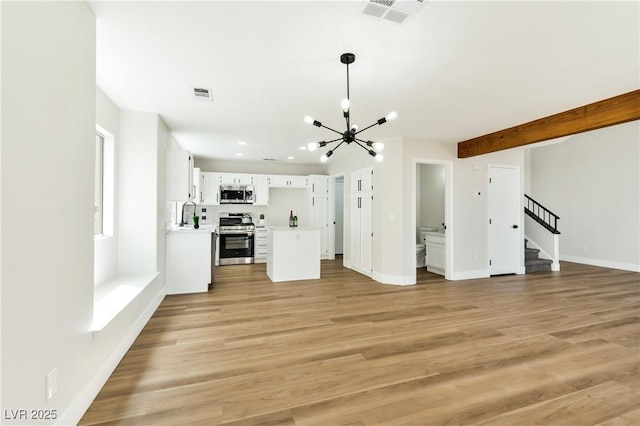 1724 Navajo Lake Way, Las Vegas, NV 89128 - unfurnished living room with a chandelier, stairs, light wood-type flooring, a sink, and recessed lighting