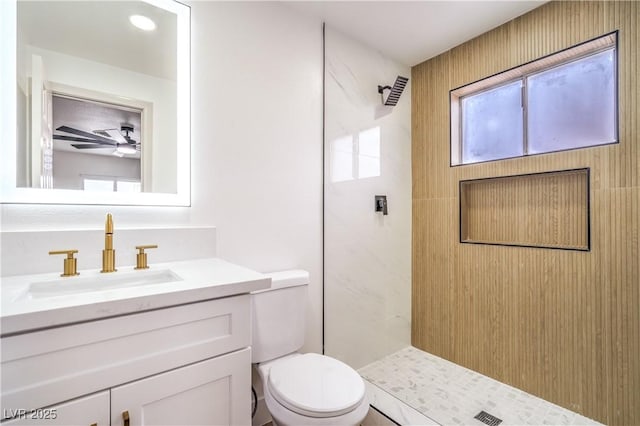 5239 Elgin Cir, Las Vegas, NV 89122 - bathroom with a tile shower, toilet, vanity, and ceiling fan