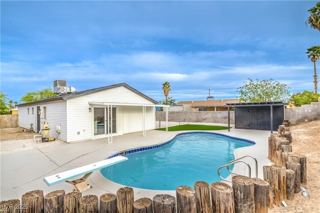 5239 Elgin Cir, Las Vegas, NV 89122 - view of pool with a patio area, a fenced backyard, and a diving board